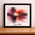 Framed abstract painting on wooden table